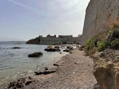 a rocky beach with a castle in the background at Fantastic sea & harbour view Nino Bixio in Castellammare del Golfo