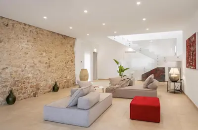 a living room with two couches and a brick wall at Historic Villa Overlooking Scopello Sea Stacks in Castellammare del Golfo