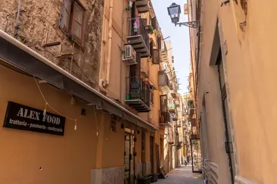 an alley between two buildings with a sign that reads alaza food at GuestHost - Don Pippo Flat near Teatro Massimo in Palermo