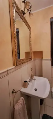a bathroom with a sink and a mirror at Casa Mazzini in Carini