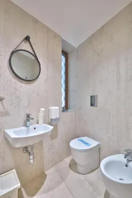 a bathroom with a sink and a toilet and a mirror at belMORO - La Dimora Del Capo in Palermo