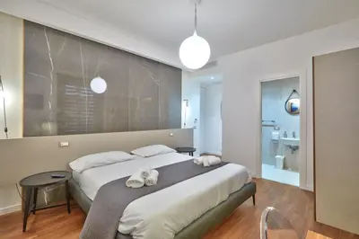 a bedroom with a large bed with two towels on it at belMORO - La Dimora Del Capo in Palermo