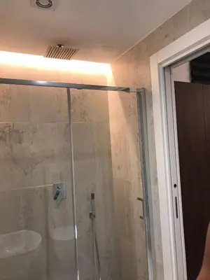 a shower with a glass door in a bathroom at belMORO - La Dimora Del Capo in Palermo