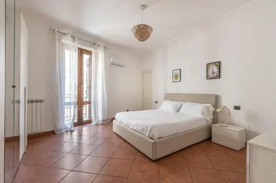 a white bedroom with a bed and a window at Gorizia Apartment by Wonderful Italy in Palermo