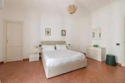 a white bedroom with a large bed and white walls at Gorizia Apartment by Wonderful Italy in Palermo