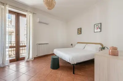 a white bedroom with a bed and a window at Gorizia Apartment by Wonderful Italy in Palermo
