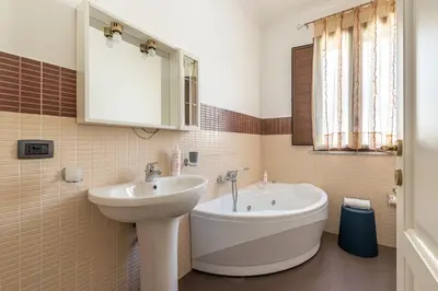 a bathroom with a sink and a bath tub at Gorizia Apartment by Wonderful Italy in Palermo