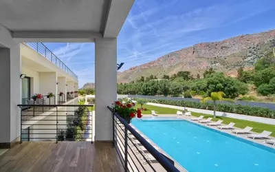 a view from the balcony of a house with a swimming pool at Ella Suites Apartments in Terrasini
