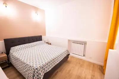 a small bedroom with a bed and a window at Flat in Center in Palermo