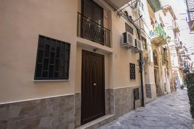a building with a door on the side of a street at Flat in Center in Palermo