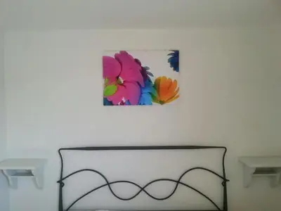 a white wall with a painting on the wall at Angolo di CIELO in Castellammare del Golfo