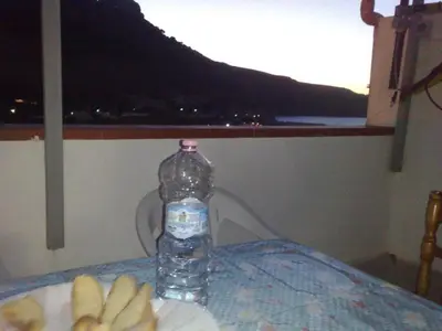 a bottle of water sitting on top of a table at Angolo di CIELO in Castellammare del Golfo