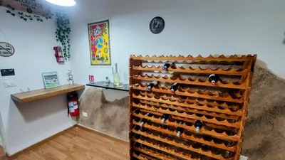 a wooden wine rack with wine bottles in a room at Roccaforte House - Palermo in Palermo
