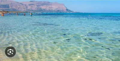 a group of people in the water at a beach at Dimora Donna Carmela in Capaci