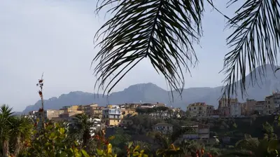 a view of a city with mountains in the background at Palmar Boutique Hotel in Campofelice di Roccella