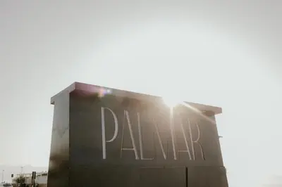 a sign on a building with the sun behind it at Palmar Boutique Hotel in Campofelice di Roccella