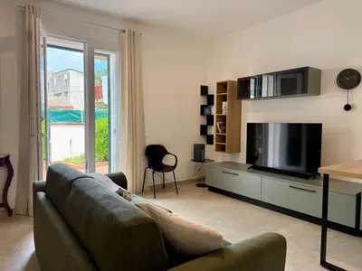 a living room with a couch and a flat screen tv at Casa Baglio Monti in Palermo