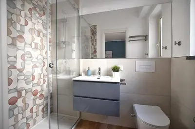 a bathroom with a toilet and a sink and a shower at iFlat Papi living in Palermo