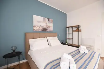 a bedroom with a large bed with white sheets at iFlat Papi living in Palermo