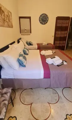two beds sitting next to each other in a room at Casa vacanze Andry in Cinisi