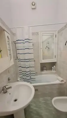 a bathroom with a sink and a bath tub and a sink at Casa vacanze Andry in Cinisi