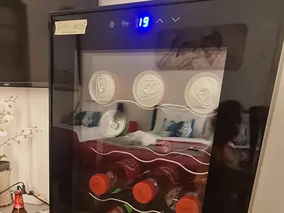 a refrigerator with bottles of wine in a room at Casa vacanze Andry in Cinisi