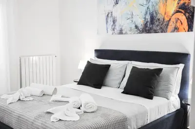 a bedroom with a bed with towels on it at Foresteria del Genio - Luxury Suites & Urban Spa in Palermo