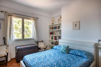 a bedroom with a bed and a book shelf at Casa Annibale con Vista Mare by Wonderful Italy in Palermo