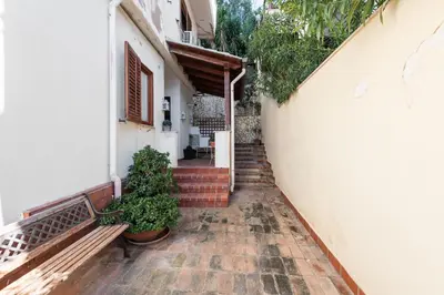 a hallway of a house with a bench and plants at Casa Annibale con Vista Mare by Wonderful Italy in Palermo
