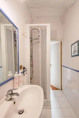 a white bathroom with a sink and a shower at Casa Annibale con Vista Mare by Wonderful Italy in Palermo