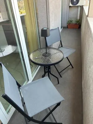 two chairs and a table on a balcony at D & C Apartment in Palermo