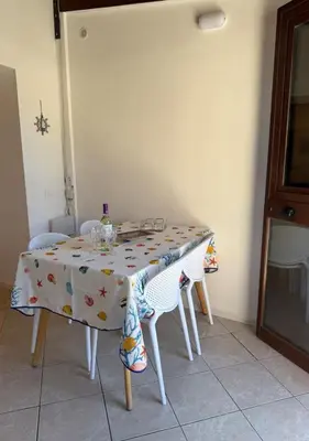 a dining room table with chairs and a table cloth at DomusSolis - Casa vacanza a 2 passi dal mare in Palermo