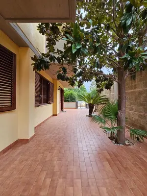 an empty hallway of a building with trees and plants at Villa Nino in Palermo
