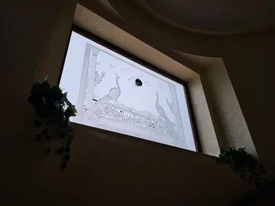 a window with a picture of two white birds at Villa Nino in Palermo