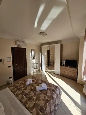 a bedroom with a large bed with towels on it at Villa Nino in Palermo
