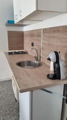a kitchen with a sink and a mixer on a counter at Il Loft di Godrano in Godrano