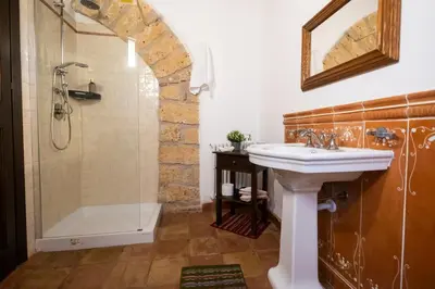 a bathroom with a sink and a shower at Villa Cannamele in Carini