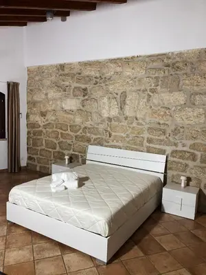 a bed in a room with a brick wall at Casa Vacanza 