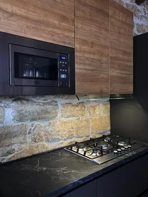 a microwave oven above a stove in a kitchen at Casa Vacanza 