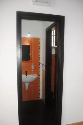 a bathroom with a white sink and orange walls at Casa Vacanza 
