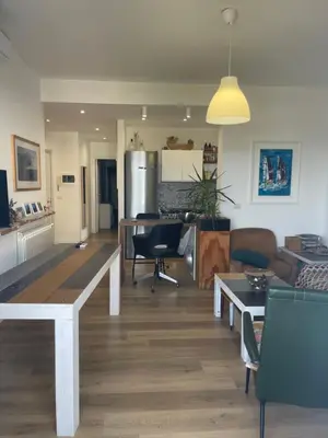 a living room with a couch and a table at la vue sur la mer in Capaci
