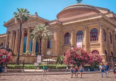 a large building with people walking in front of it at Damas Home in Palermo