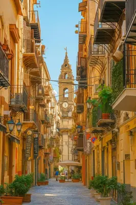 a city street with a clock tower in the distance at Orologio21-Soggiorna al teatro Massimo in Palermo