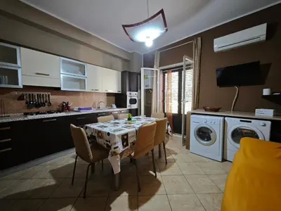 a kitchen with a table and chairs in a kitchen at Casa Pitrè in Palermo