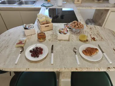 a table with plates of food on top of it at Quintadecima Rooms in Palermo