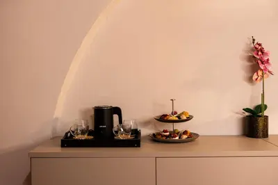 a table with a coffee maker and a plate of food at Chiave di Volta luxury suite e rooms in Palermo