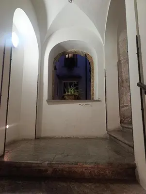 an archway in a building with a potted plant at Maria's apartment alla Magione, appartamento in centro in Palermo