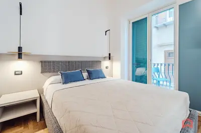 a bedroom with a large bed with blue pillows at Nuovissimo Appartamento nel Cuore di Palermo in Palermo