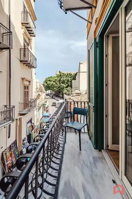 a balcony with chairs and a view of a street at Nuovissimo Appartamento nel Cuore di Palermo in Palermo