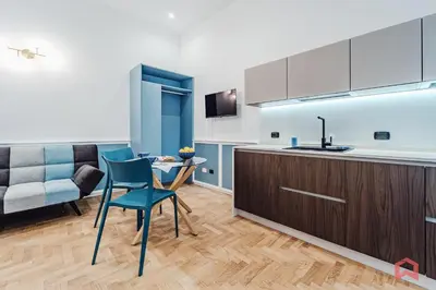 a kitchen with a table and chairs and a couch at New Holiday Home in Palermo in Palermo